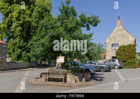 The village square in the pretty North Yorkshire village of Kilburn; free car parking but a sign indicates donations welcome. Stock Photo