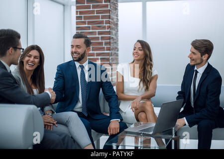 handshake business partners in an informal meeting Stock Photo