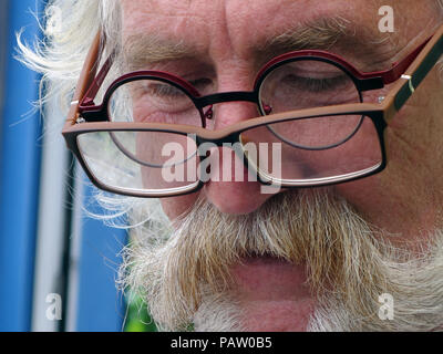 Really closeup of Silver haired man wearing two pairs of glasses at the same time. Property and Model released Stock Photo