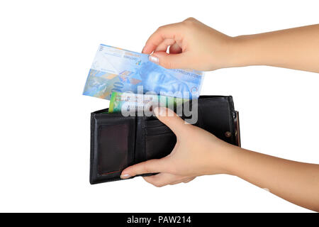 the woman pulls out a Swiss francs from her purse isolated on white background Stock Photo
