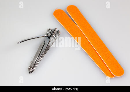 Nail clipper and two nail files sitting on a white counter Stock Photo
