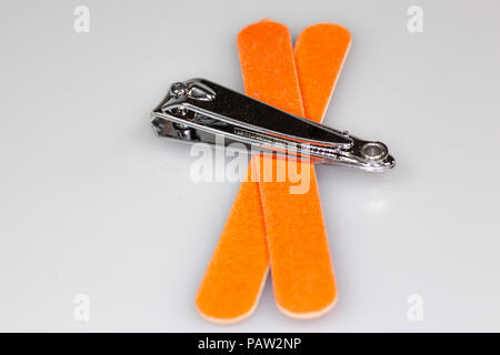 Nail clipper and two nail files sitting on a white counter Stock Photo