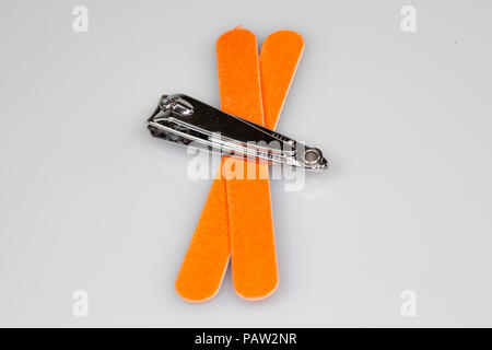 Nail clipper and two nail files sitting on a white counter Stock Photo