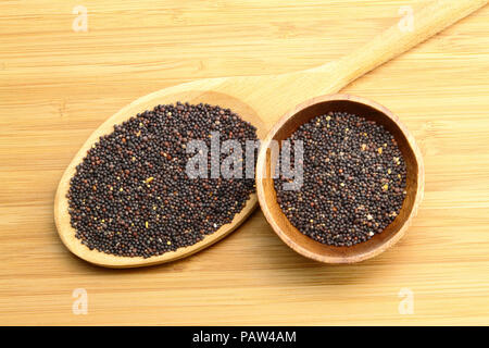 Spoon of Mustard Seed Nigra on wood Stock Photo