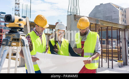 Experienced architect analyzing a blueprint on the construction  Stock Photo