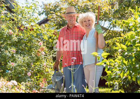 Active happy senior woman standing next to her husband Stock Photo