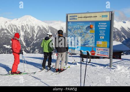 BAD HOFGASTEIN, AUSTRIA - MARCH 9, 2016: People analyze map in Bad Hofgastein. It is part of Ski Amade, one of largest ski regions in Europe with 760k Stock Photo