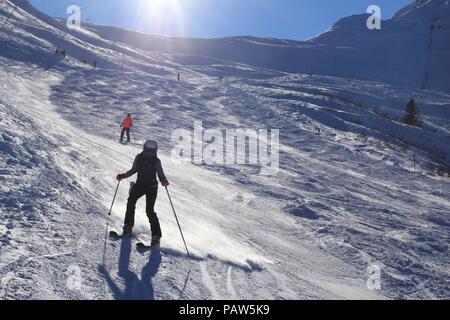 BAD HOFGASTEIN, AUSTRIA - MARCH 9, 2016: People ski in Bad Hofgastein. It is part of Ski Amade, one of largest ski regions in Europe with 760km of ski Stock Photo