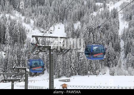 BAD HOFGASTEIN, AUSTRIA - MARCH 7, 2016: People ride gondolas of cable car in Bad Hofgastein. It is part of Ski Amade, one of largest ski regions in E Stock Photo