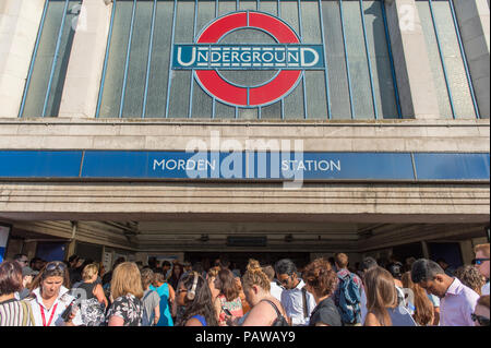 Morden Underground Station, London, UK. 25 July, 2018. Southern terminus station on the Northern Line is closed at 08.20am during the peak of the morning rush hour due to a reported fire incident in the south bound tunnel. All trains to and from Morden stopped while the incident was investigated, with large build up of passengers outside the station. Credit: Malcolm Park/Alamy Live News. Stock Photo