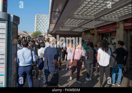 Morden Underground Station, London, UK. 25 July, 2018. Southern terminus station on the Northern Line is closed at 08.20am during the peak of the morning rush hour due to a reported fire incident in the south bound tunnel. All trains to and from Morden stopped while the incident was investigated, with large build up of passengers outside the station. Credit: Malcolm Park/Alamy Live News. Stock Photo