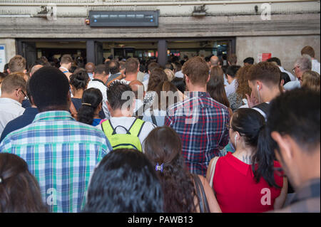 Morden Underground Station, London, UK. 25 July, 2018. Southern terminus station on the Northern Line is closed at 08.20am during the peak of the morning rush hour due to a reported fire incident in the south bound tunnel. All trains to and from Morden stopped while the incident was investigated, with large build up of passengers outside the station. Credit: Malcolm Park/Alamy Live News. Stock Photo