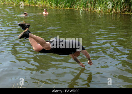 Man diving into a river to cool down during a heatwave in the UK Stock Photo