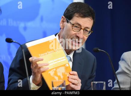 Washington, USA. 24th July, 2018. Maurice Obstfeld, Economic Counsellor and Director of Research at the International Monetary Fund (IMF), shows the newly-released 2018 External Sector Report at a press conference in Washington, DC, the United States, on July 24, 2018. Credit: Yang Chenglin/Xinhua/Alamy Live News Stock Photo
