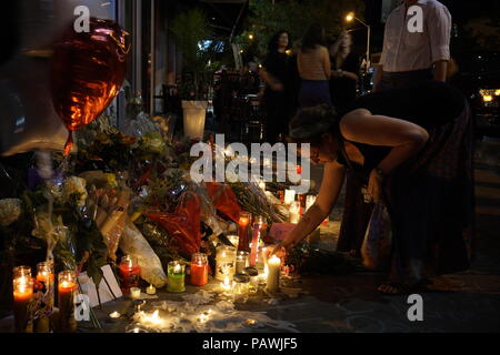 Toronto, Canada. 25th July 2018. After deadly mass shooting on Toronto Danforth Greek Town on July 22, 2018, people are leaving flowers, candles and message in one of the shooting location - Demetres Danforth Cafe where a 10-year old girl was shot and killed Credit: CharlineXia/Alamy Live News Stock Photo