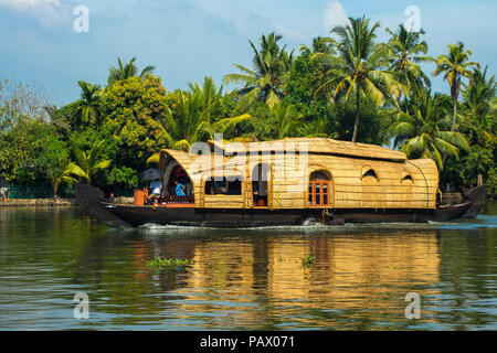 A native style bamboo and thatch houseboat for river tours in the Kerala backwaters, India Stock Photo