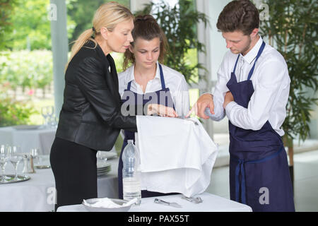 young workers servicing food in cafeteria Stock Photo