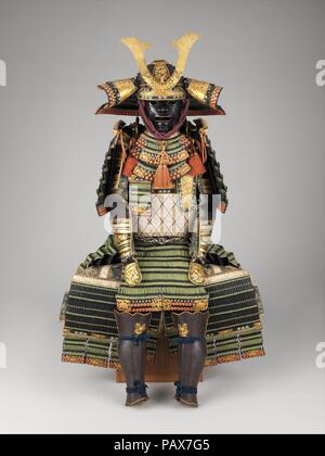 Armor (Yoroi). Culture: Japanese. Dimensions: as mounted: H. 58 1/2 in. (148.6 cm); W. 34 1/2 in. (87.6 cm); D. 28 in. (71.1 cm). Date: 18th century.  During the eighteenth century, there was a revival of interest in medieval Japanese culture. As the demand for historical styles of armor began to increase among the wealthy lords, contemporary armorers studied the older forms and techniques in order to duplicate them. This example imitates a <i>yoroi</i> of the twelfth to thirteenth century. It is characterized by a helmet with prominent rivet heads and a wide, flaring neck guard and by a large Stock Photo