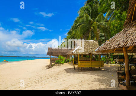 Native bamboo and Nipa huts on a tropical island beach - Siargao Island Village, Philippines Stock Photo