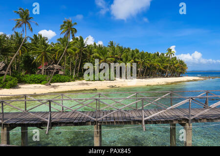 Wooden Beach Boardwalk and island palm trees on sunny day at Cloud 9 -  Siargao Philippines Stock Photo
