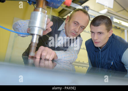 young male engineer in factory using milling machine Stock Photo