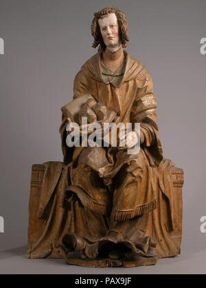 Saint Stephen. Artist: Hans Leinberger (German, active 1510-1530). Culture: South German. Dimensions: Overall: 33 x 21 1/2 x 8 1/2in. (83.8 x 54.6 x 21.6cm). Date: ca. 1525-30.  Saint Stephen sits upon a low, partially draped, backless bench.  He wears a dalmatic over a long tunic, indicating his position in the church as a deacon, and in his right hand he holds an open book supporting three rocks, referring to his death by stoning.  Revered as the first Christian martyr, Stephen's story is recounted in the Acts of the Apostles (6-7).    The work is carved from three pieces of wood: one was us Stock Photo