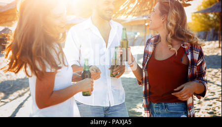Group of happy friends partying on beach Stock Photo