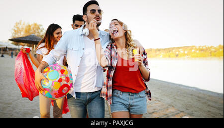 Group of happy friends partying on beach Stock Photo