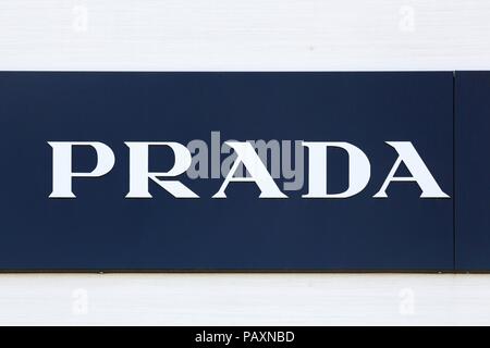 Nimes, France - July 1, 2018: Prada logo  on a wall. Prada is an Italian luxury fashion house, specializing in leather handbags, travel accessories Stock Photo
