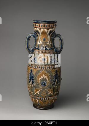 Vase. Culture: British, Lambeth, London. Dimensions: Overall (confirmed): 19 1/2 × 8 3/16 × 8 1/16 in. (49.5 × 20.8 × 20.5 cm). Maker: Frank A. Butler (British). Manufactory: Doulton Manufactory (British). Date: 1879.  Determined that pottery vessels should be regarded as true works of art, avant-garde ceramicists in France in the last decades of the nineteenth century transformed their craft into an intellectual and emotional endeavor. The pioneers of this revival were Jean Carriès, Ernest Chaplet, Théodore Deck, and Auguste Delaherche. These revolutionary artist-potters embraced artisanal tr Stock Photo