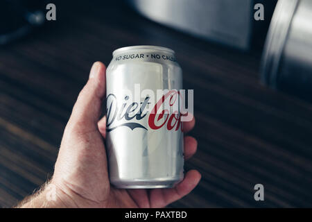 LONDON - July 18, 2018: Can of Diet Coke held in hand at home kitchen Stock Photo