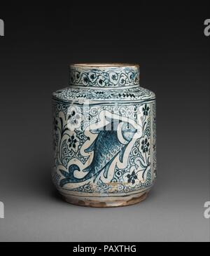 Pharmacy Jar. Culture: Italian. Dimensions: Overall: 9 x 7 3/16 in. (22.9 x 18.3 cm). Date: 1400s.  Maiolica storage jars for Italian pharmacies were highly decorative and frequently combined animal and floral motifs, as demonstrated by this particularly fine pair. Museum: Metropolitan Museum of Art, New York, USA. Stock Photo