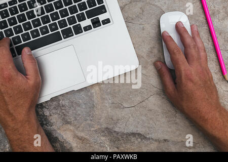 Man working with laptop computer and mouse on marble background Stock Photo