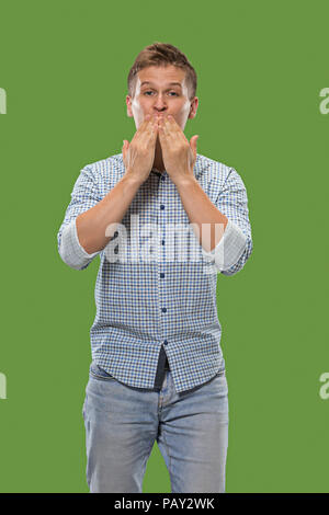 Portrait of attractive man with kiss isolated over green background Stock Photo