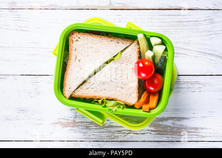 Lunch box with sandwich and vegetables. Stock Photo