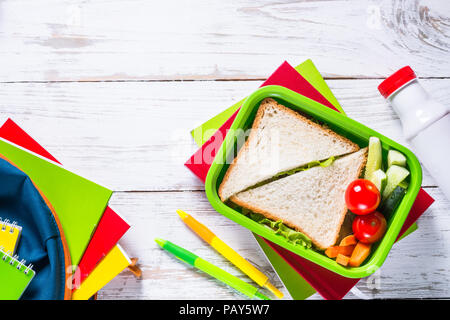 Back to school concept. Lunch box, stationery and backpack. Stock Photo