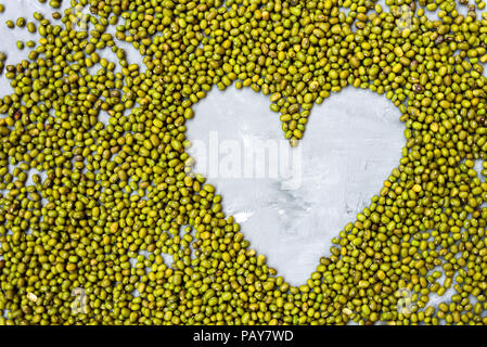 Heart shaped Mung beans texture background. flat lay, copy space Stock Photo