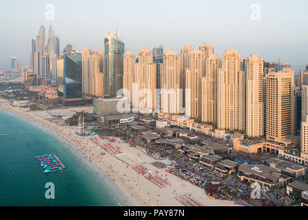 DUBAI, UAE - February 16, 2018: Aerial view of modern skyscrapers and beach at Jumeirah Beach Residence (JBR) during sunset in Dubai, UAE Stock Photo