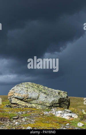 Rocks with dark thunderstorm clouds in the sky Stock Photo