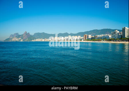 Scenic panoramic view of Ipanema Beach from the rocks at Arpoador with the city skyline in Rio de Janeiro Brazil Stock Photo