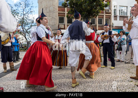 Funchal, Portugal - April 19, 2018:  Folk musicians and dancers performing on the Avenida Arriaga  in Funchal on the Madeira Island, Portugal. Stock Photo