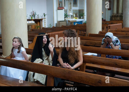 Christianity people UK. Mother and children christian upbringing who will take part in the annual Saint Peters,  St Peters Italian Church procession London Uk 2010s HOMER SYKES Stock Photo