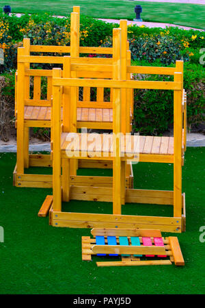 Sharm el-Sheikh, Egypt - March 14, 2018. Children's wooden multi-colored game constructions on a background of green artificial grass. Accommodation i Stock Photo