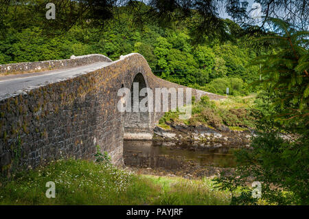 The Clachan Bridge is a single-arched, hump-backed, masonry bridge spanning the Clachan Sound, near Oban in Argyll, Scotland. It links the west coast  Stock Photo