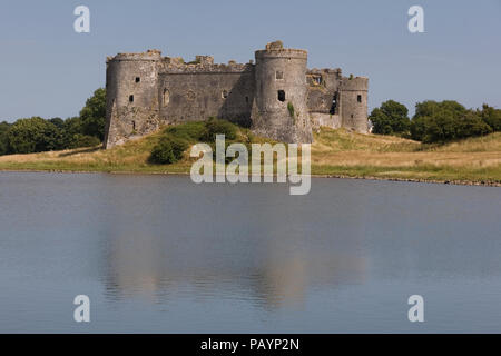 Carew castle at its waterfront location on an inlet of Milford Haven in Pembrokeshire Coast National Park Stock Photo