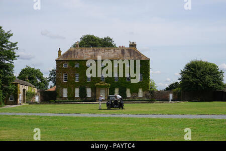 Crakehall Mansion and Village Green with a Classic Car Yorkshire Dales England Stock Photo