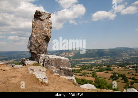 The Lonely Sheperd looking over the Usk Valley with the Sugarloaf mountain behind. A piller of limestone left by the workers at the limestone quarry. Stock Photo