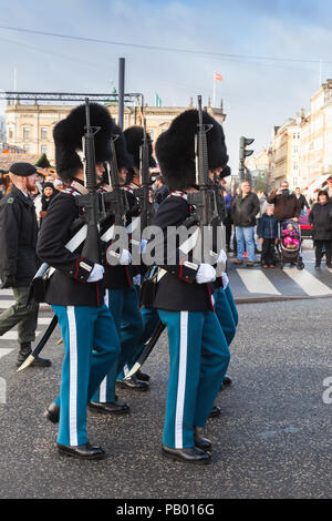 Copenhagen, Denmark - December 9, 2017: Procession of the royal guardsmen to the royal palace Amalienborg, accompanied by the orchestra. The ceremony  Stock Photo