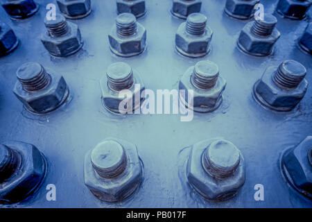 Screws, bolts, nuts tightened on the metal plates Stock Photo