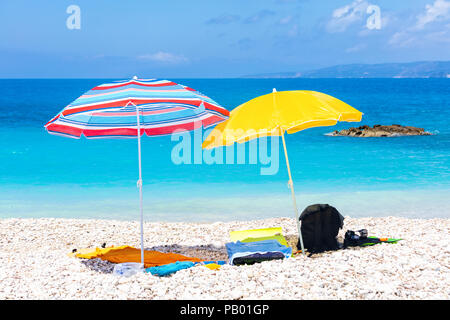 Two umbrellas with bedding on the white beach Stock Photo